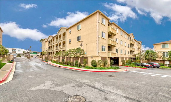 Front view of a multi-story residential building with balconies.