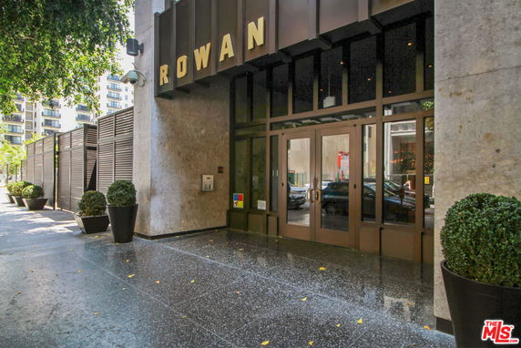Front view of a commercial building entrance with glass doors.
