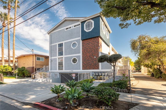 Front view of a multi-story building with a unique geometric window design.