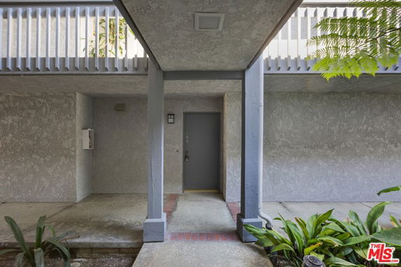 Front view of a building entrance with a covered walkway.