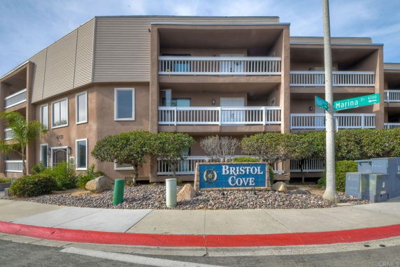Front view of a multi-story apartment building with balconies.