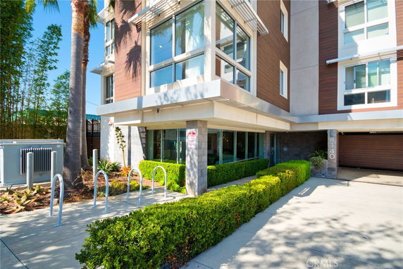 Front view of a modern multi-story building with large windows.