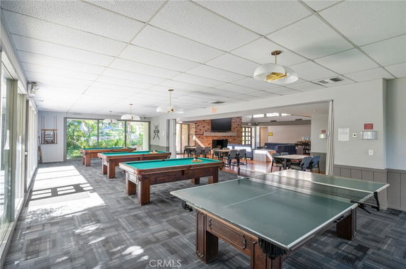 Indoor recreation area with pool tables and table tennis.