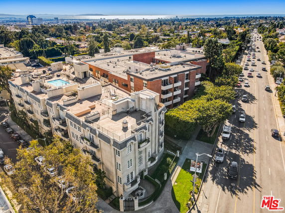 Aerial view of apartment buildings with surrounding residential and urban areas.