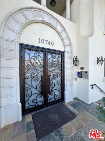 Front entrance of a building with ornate double doors and address number 10740.