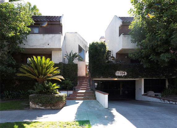 Front view of a multi-story residential building with garages.
