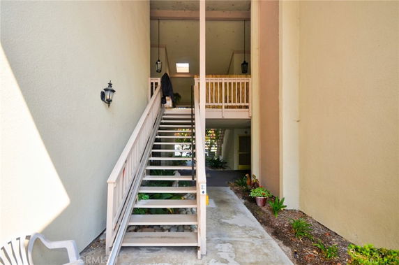 Entrance of a building with stairs leading to an upper level.