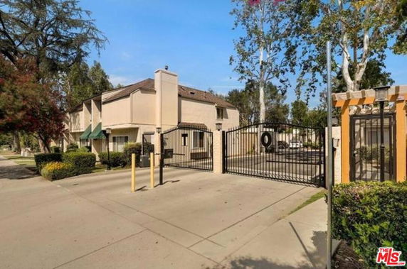 Front view of a residential building with a gated entrance.