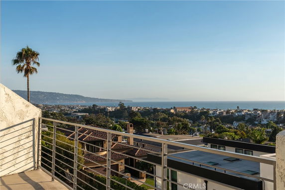 Panoramic view of a coastal city seen from a building, with a view of the ocean and surrounding areas.