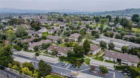 Panoramic view of a residential area with multiple buildings and green spaces.