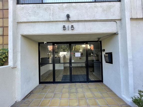 Entrance view of a building with glass doors.