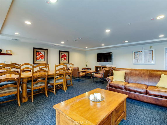 Indoor recreation room with seating area and large dining table.