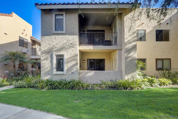 Front view of an apartment building with a balcony.