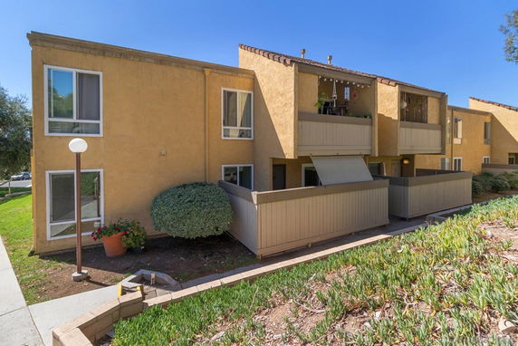 Front view of a multi-story residential building with balconies.