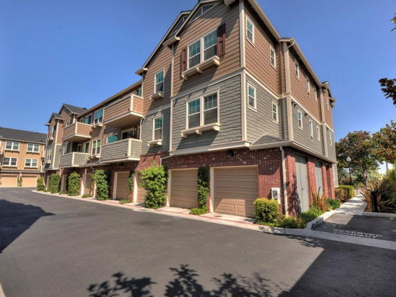 Front view of a multi-story residential building with garages.