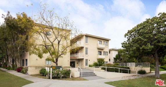 Front view of a multi-story apartment building with balconies.