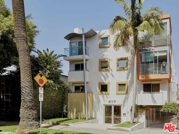 Front view of a modern multi-story building with balconies.