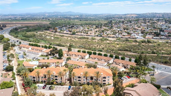 Panoramic view of residential complex with multiple buildings and surrounding landscape.