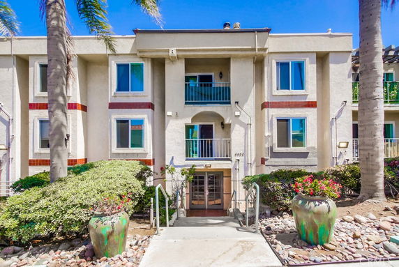 Front view of a multi-story residential building with balconies.