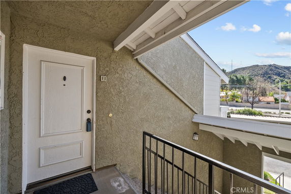 View from the entrance of a residential building with railing and door visible.