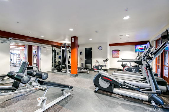 Interior view of a gym with exercise machines and equipment.
