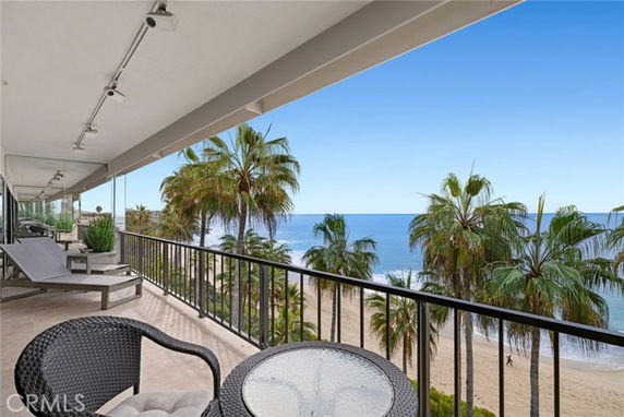 Panoramic view from a balcony overlooking the beach and ocean.