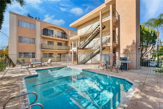 Outdoor view of a building with a swimming pool and balconies.