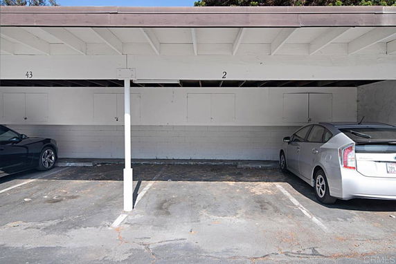 Covered parking area with two vehicles.
