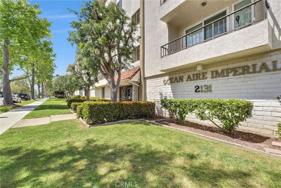 Front view of a multi-story building with balconies and a sign 'OCEAN AIRE IMPERIAL 2131'.