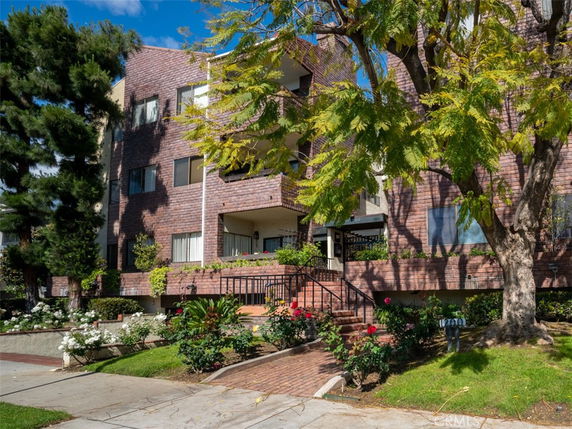 Front view of a multi-story brick apartment building.