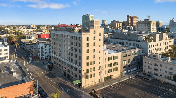 Front view of a multi-story urban building with large windows.
