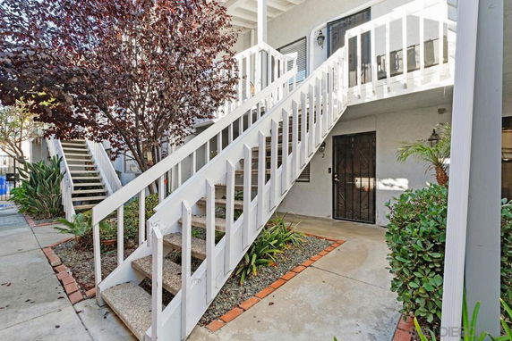 Front view of a building with exterior staircases and entryways.