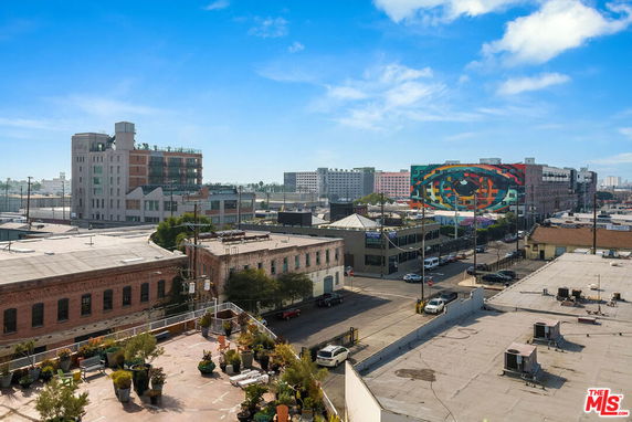 Panoramic view of a cityscape with buildings and street art.