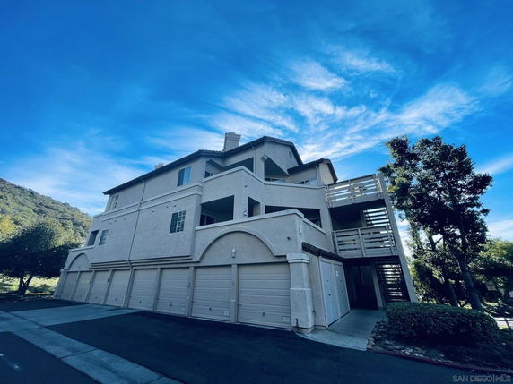 Front view of a multi-story building with multiple garages.