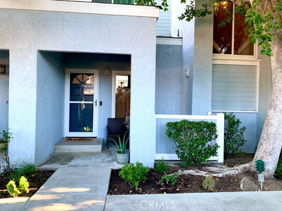 Front view of a house entrance with a small porch and blue exterior walls.