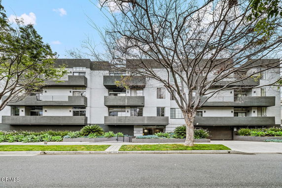 Front view of a multi-story residential building with balconies.