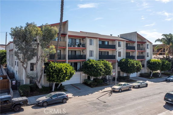 Front view of a multi-story apartment building with balconies.
