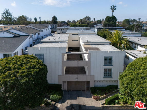 Front view of a multi-story apartment building with a central open space.