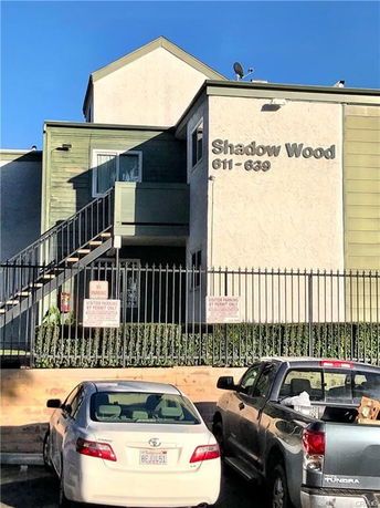 Front view of a multi-story building with external stairs.