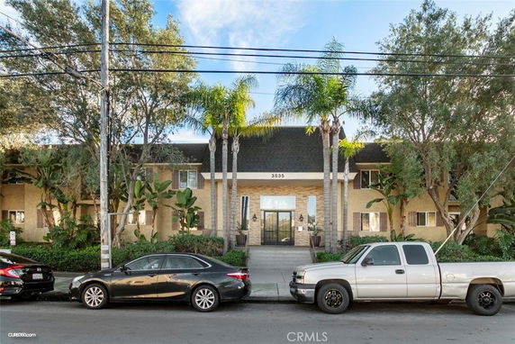 Front view of a multi-story residential building with a central entrance.