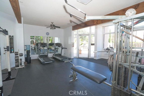 Indoor gym area with exercise equipment including treadmills and weight machines.
