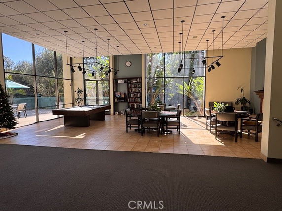 Interior of a recreation area with pool table and seating.