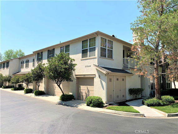 Front view of a two-story residential building with garages.