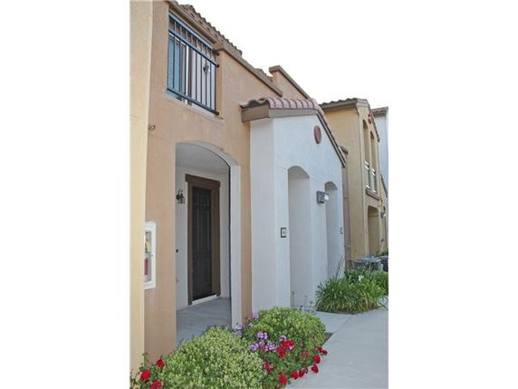 Front view of a multi-story house with a balcony.