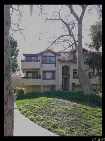 Front view of a multi-story residential building with balconies.
