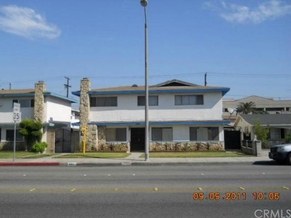 Front view of a two-story building with stone accents and blue trim.