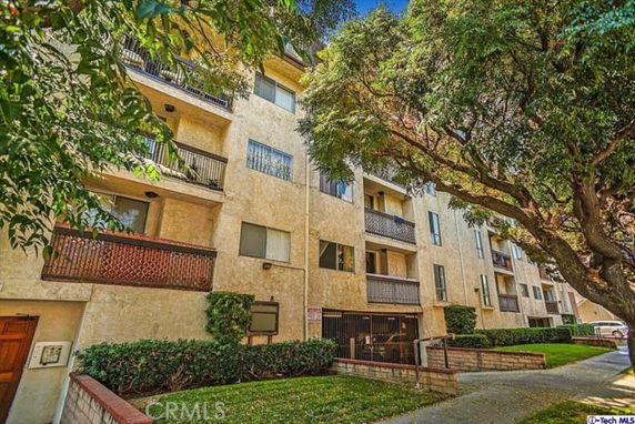 Front view of a multi-story apartment building with balconies.