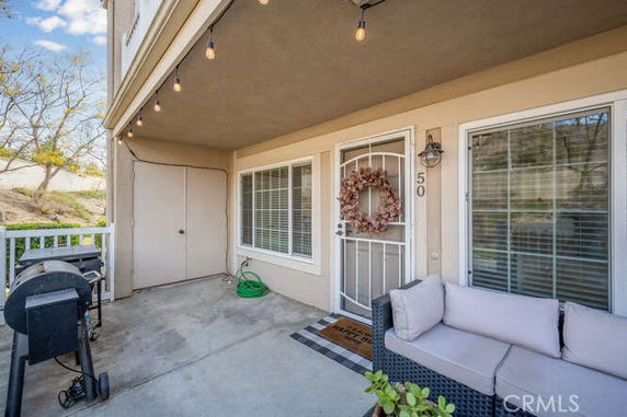 Front view of a house with a small porch area and a decorated entrance door.