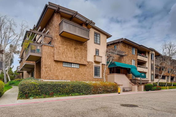 Front view of a multi-story apartment building with balconies.