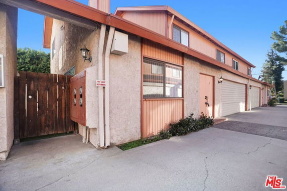 Front view of a multi-unit building with garage doors.